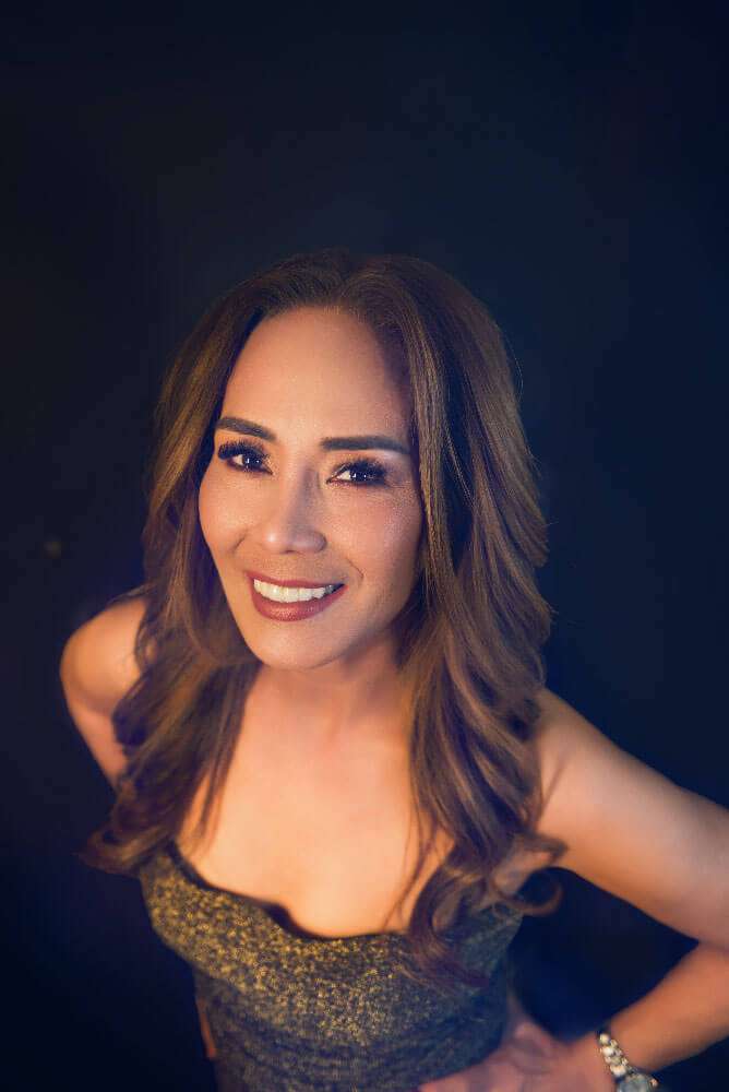 Close-up of Imee smiling in a gold sequin top from her 60th birthday portrait session in Brisbane