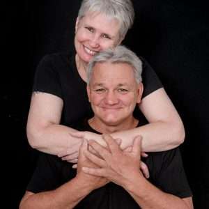 Mature couple embracing with crossed arms in a black-and-white portrait, Brisbane family photography by Twin Lotus Production, Brisbane family photographer