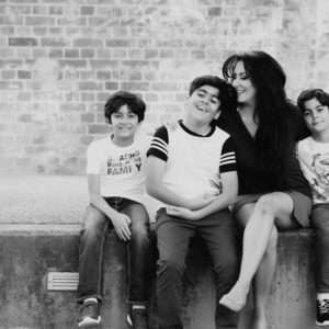 Mum with her three sons in a black-and-white portrait at Brisbane Powerhouse, family photography by Twin Lotus Production, Brisbane family photographer