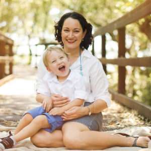 Mum laughing with her giggling toddler on a timber deck in Wynnum-Manly, family portrait session by Twin Lotus Production, Brisbane family photographer