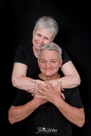 Mature couple embracing with crossed arms in a black-and-white portrait, Brisbane family photography by Twin Lotus Production, Brisbane family photographer