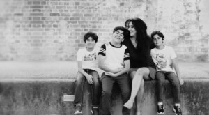 Mum with her three sons in a black-and-white portrait at Brisbane Powerhouse, family photography by Twin Lotus Production, Brisbane family photographer
