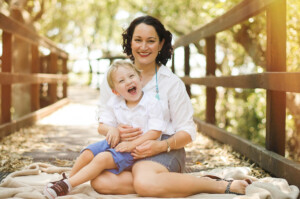 Mum laughing with her giggling toddler on a timber deck in Wynnum-Manly, family portrait session by Twin Lotus Production, Brisbane family photographer